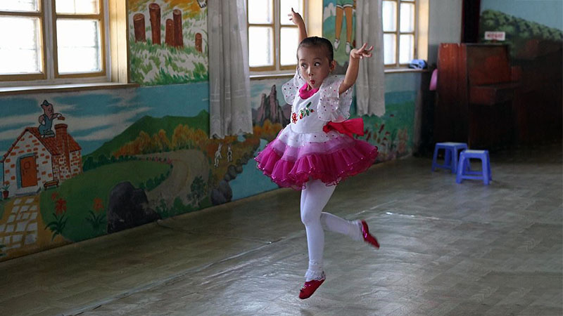 Child ballet dancer in classroom